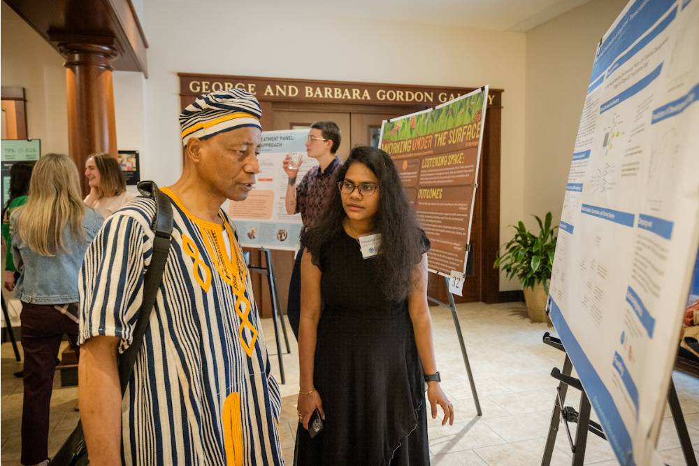 Hemalatha Sabbineni showing her research to a professor
